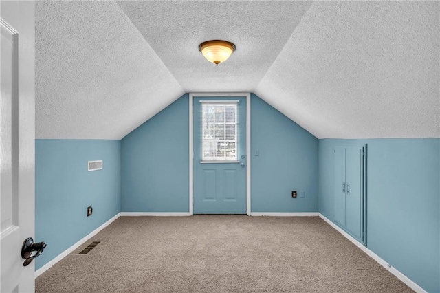 bonus room with visible vents, lofted ceiling, baseboards, and carpet flooring