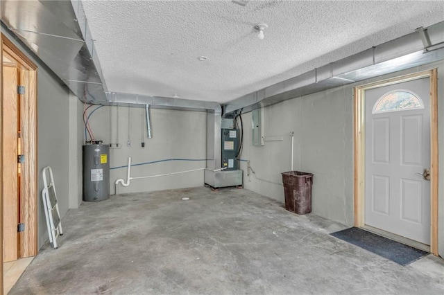 below grade area with a textured ceiling, heating unit, and electric water heater