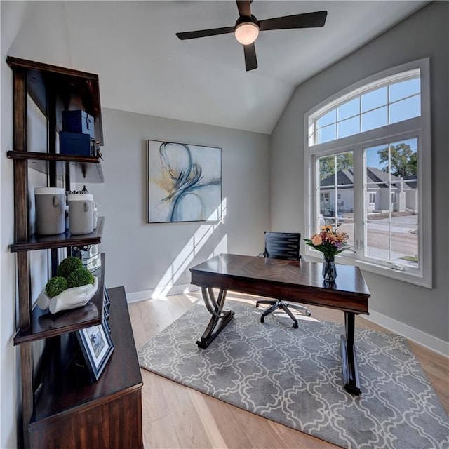 office with ceiling fan, light hardwood / wood-style flooring, and lofted ceiling