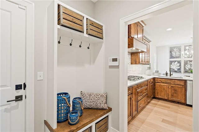 mudroom with sink and light wood-type flooring