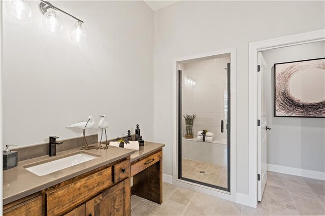 bathroom with a shower with shower door, tile patterned floors, and vanity