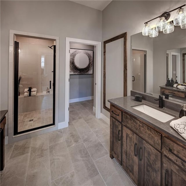 bathroom with tile patterned floors, vanity, and a shower with door