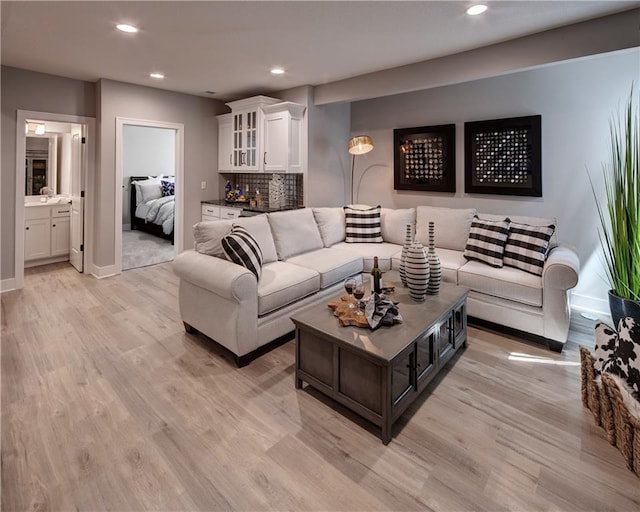 living room featuring sink and light hardwood / wood-style floors