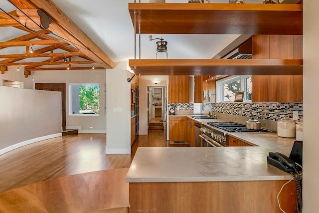 kitchen with backsplash, a healthy amount of sunlight, and sink