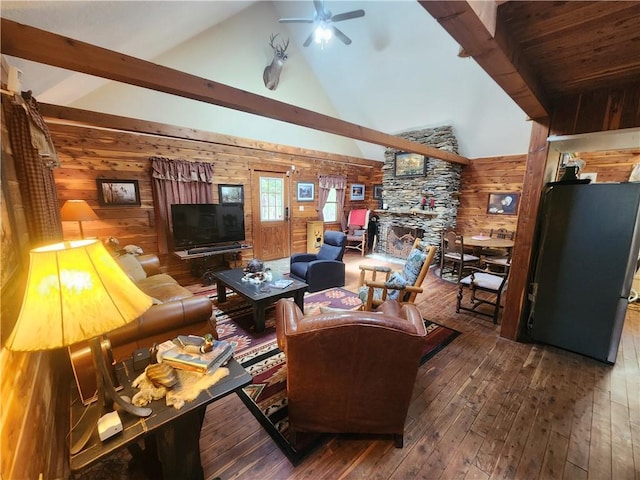 living room with dark wood-type flooring, high vaulted ceiling, wooden walls, ceiling fan, and a fireplace