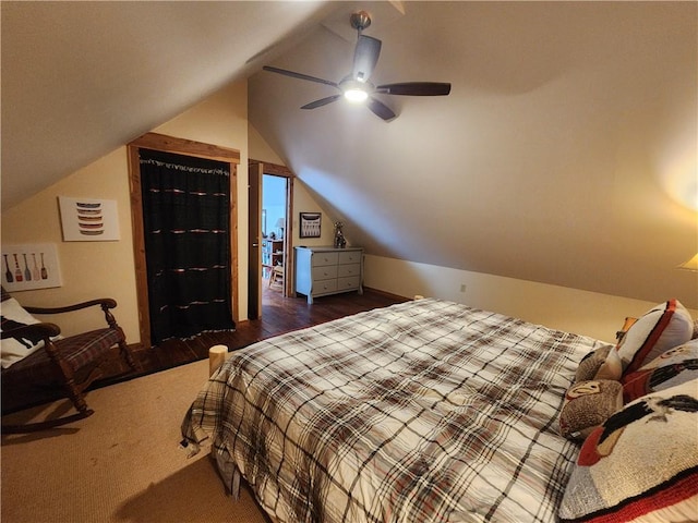 bedroom with ceiling fan, dark hardwood / wood-style floors, and vaulted ceiling