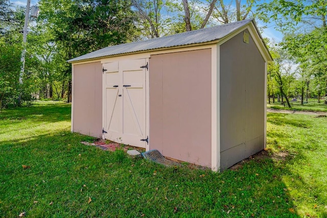 view of outdoor structure with a lawn