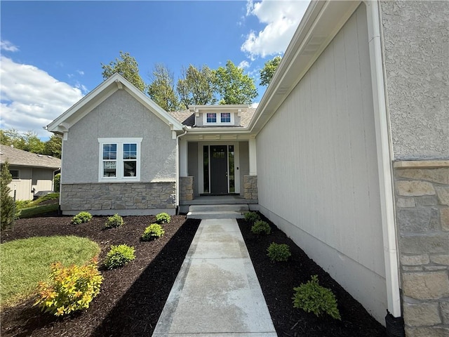 doorway to property featuring stone siding
