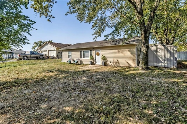 view of front of home with a front lawn and a storage unit