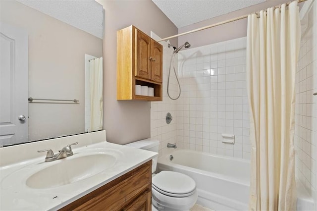 full bathroom with vanity, a textured ceiling, shower / tub combo with curtain, and toilet