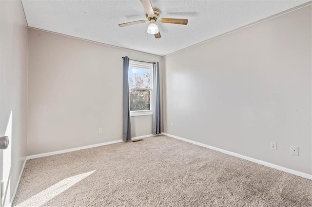 spare room featuring a textured ceiling, carpet floors, and ceiling fan