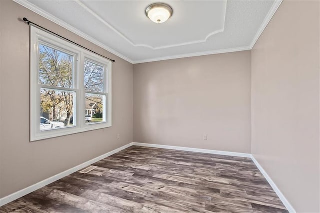 empty room with dark hardwood / wood-style floors and crown molding