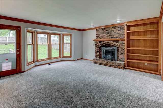 unfurnished living room featuring crown molding, a fireplace, and carpet