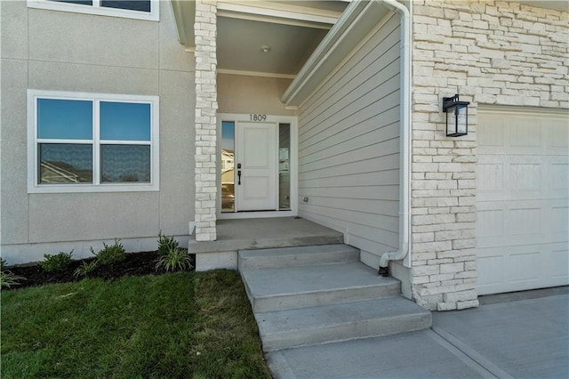 view of exterior entry featuring a garage