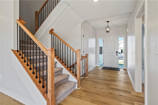 foyer entrance featuring a chandelier and hardwood / wood-style floors