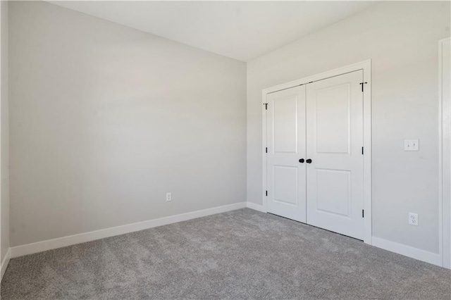 unfurnished bedroom with carpet and a closet