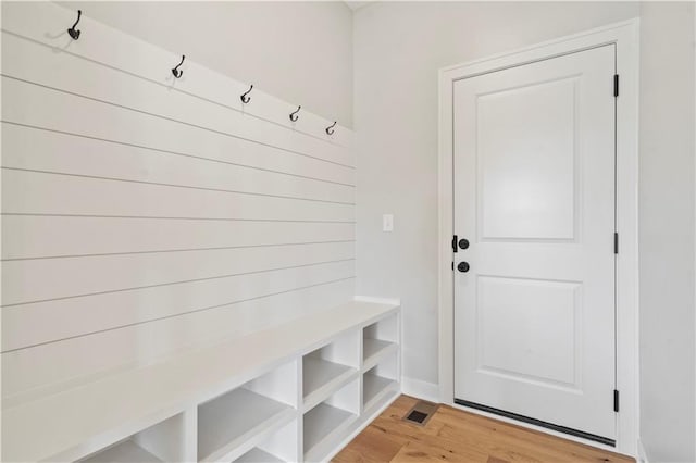 mudroom with light hardwood / wood-style flooring