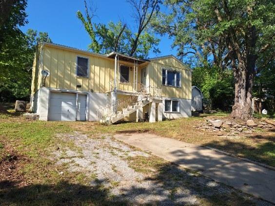 view of front of property featuring a porch and a garage