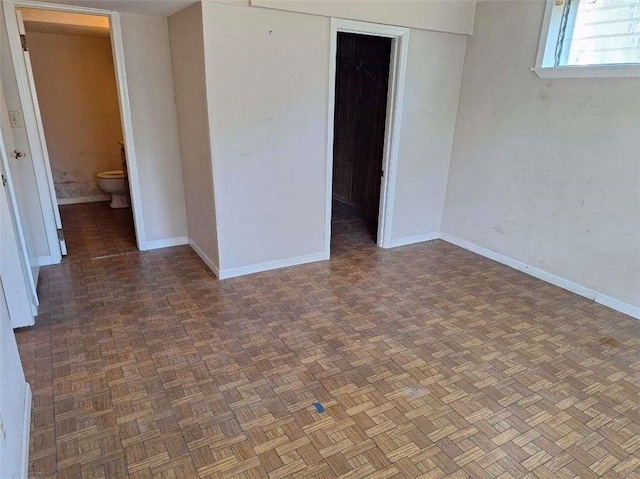 unfurnished room featuring dark parquet floors