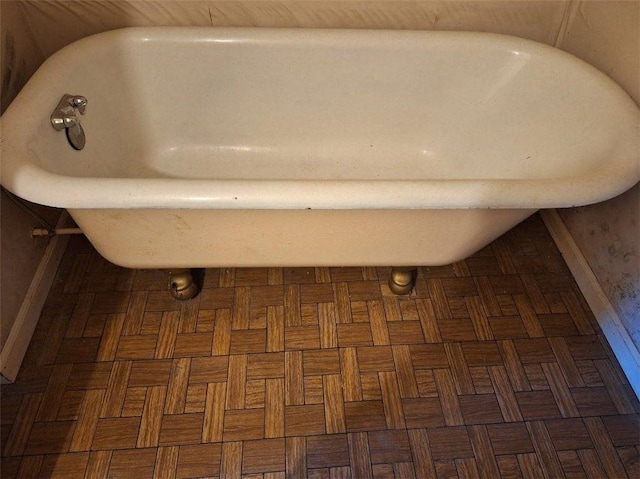 details featuring a bathtub and parquet flooring