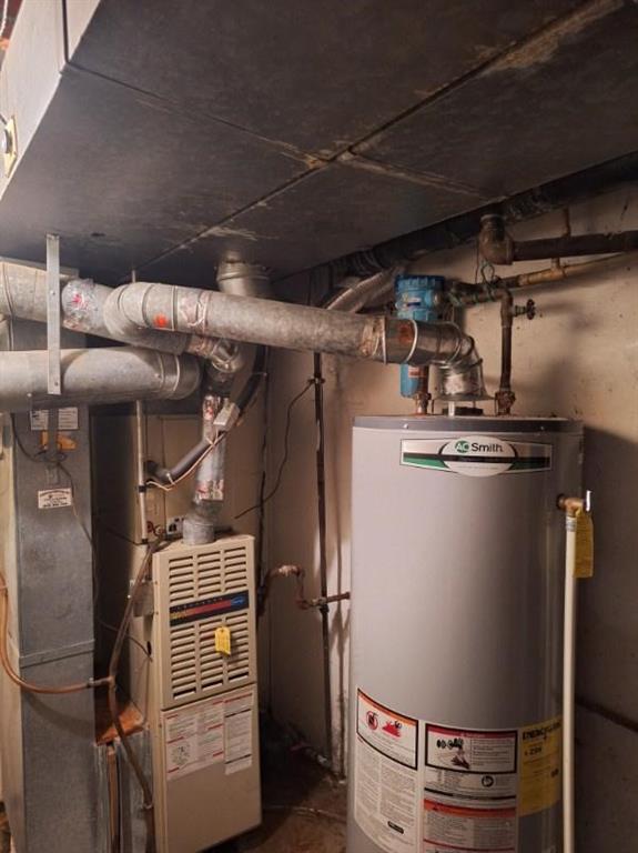 utility room featuring gas water heater