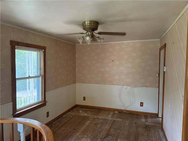 empty room with dark wood-type flooring, ornamental molding, and ceiling fan