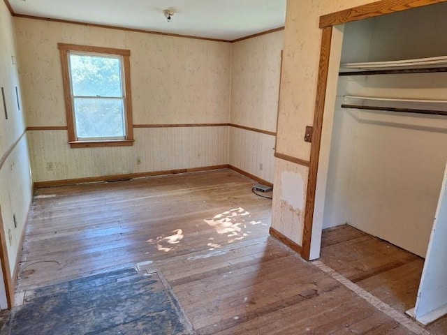 unfurnished bedroom featuring ornamental molding and light wood-type flooring