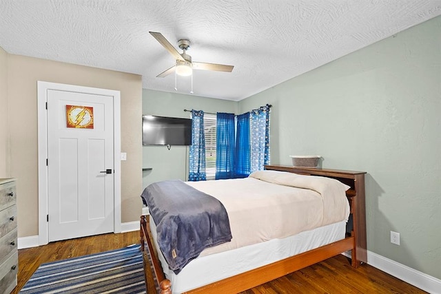 bedroom featuring a textured ceiling, ceiling fan, and wood-type flooring