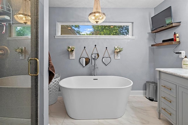 bathroom with vanity, a healthy amount of sunlight, and tile patterned flooring