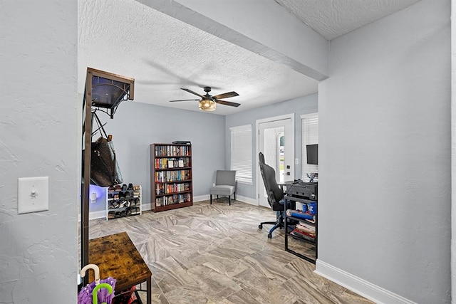 office area with a textured ceiling and ceiling fan