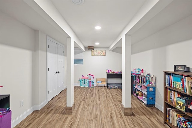 rec room with light hardwood / wood-style floors