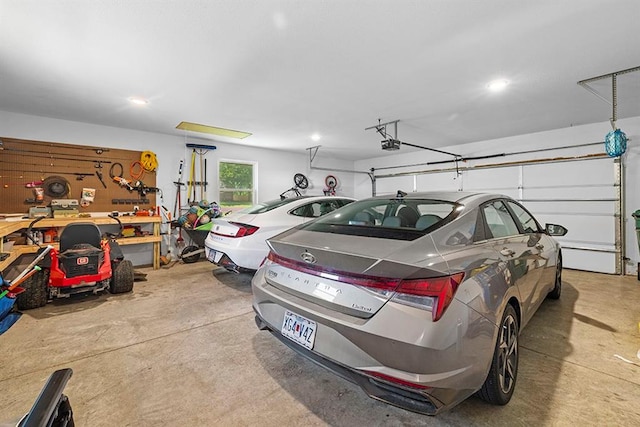 garage with a workshop area and a garage door opener