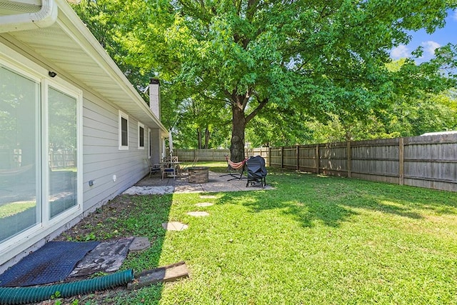 view of yard featuring a patio area and an outdoor fire pit