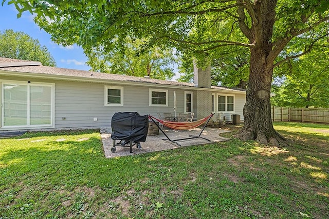 back of house with a yard and a patio area