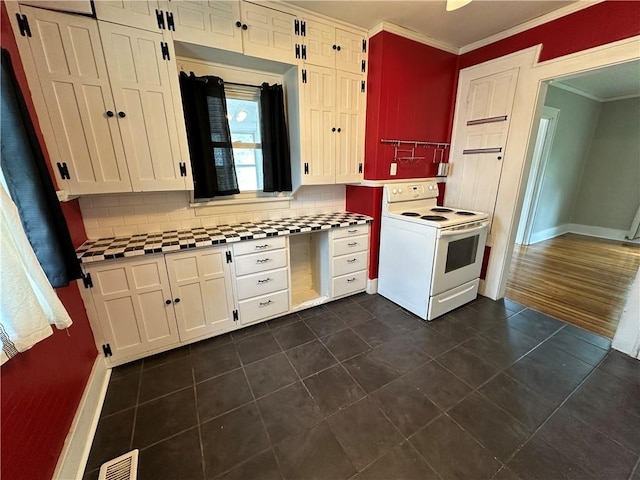 kitchen with decorative backsplash, white cabinets, crown molding, and electric stove