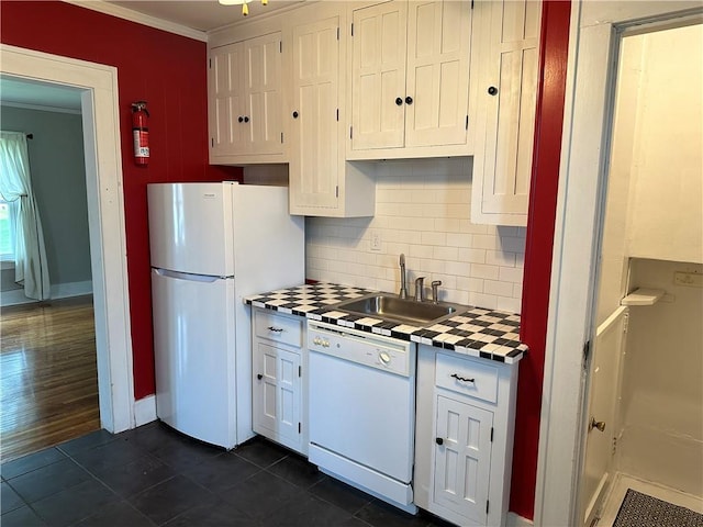 kitchen featuring backsplash, crown molding, white cabinets, white appliances, and a sink