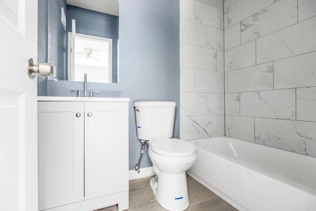 full bathroom featuring vanity, tiled shower / bath combo, and toilet