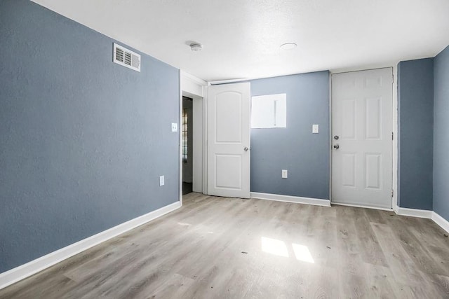 spare room with light hardwood / wood-style floors