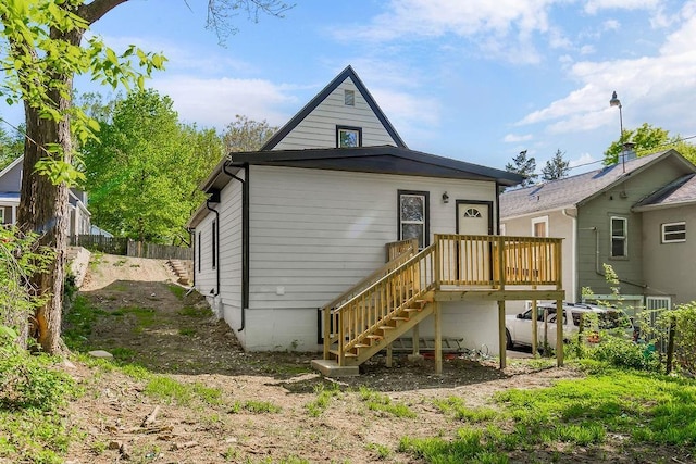 back of house featuring a wooden deck