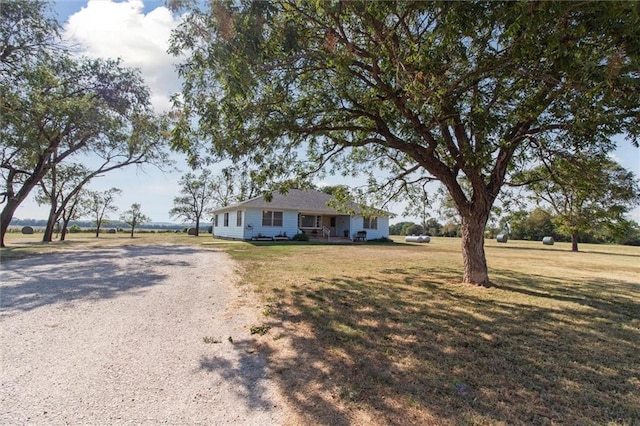 ranch-style home featuring a front yard and driveway