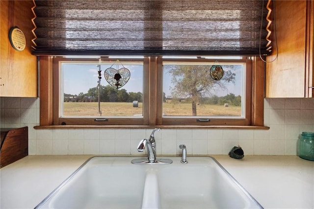 room details featuring light countertops, backsplash, and a sink