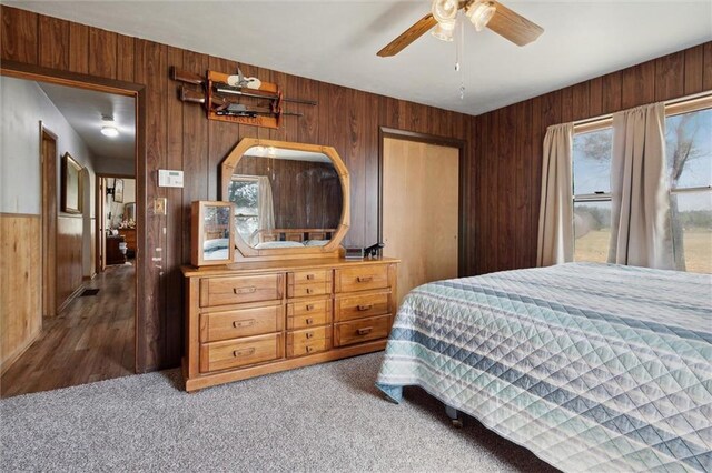 bedroom featuring multiple windows, ceiling fan, and carpet floors