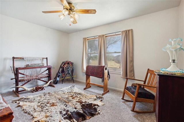 living area featuring ceiling fan and carpet floors