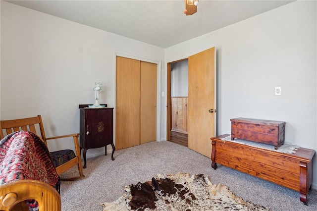 bedroom with a closet, ceiling fan, and light carpet