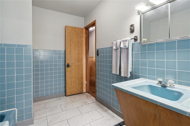 bathroom with vanity, tile walls, and tile patterned flooring