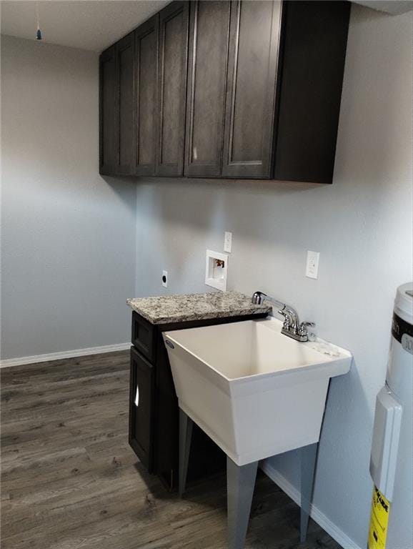 laundry room with hookup for a washing machine, electric dryer hookup, dark hardwood / wood-style flooring, and strapped water heater