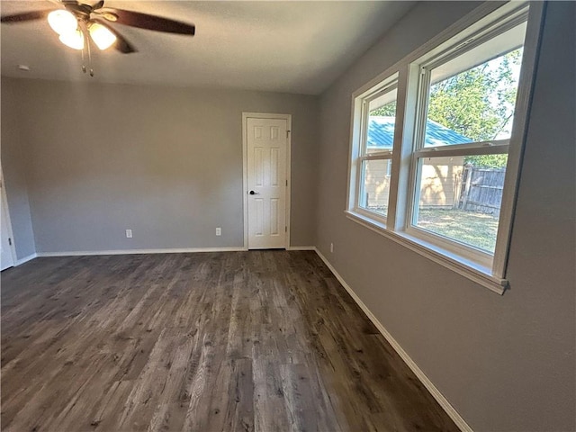 unfurnished room featuring ceiling fan and dark hardwood / wood-style floors