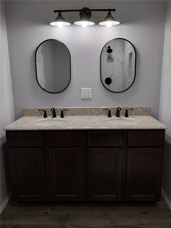 bathroom with vanity and wood-type flooring