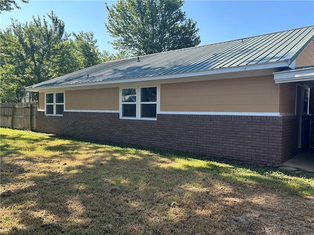 view of side of home featuring a lawn