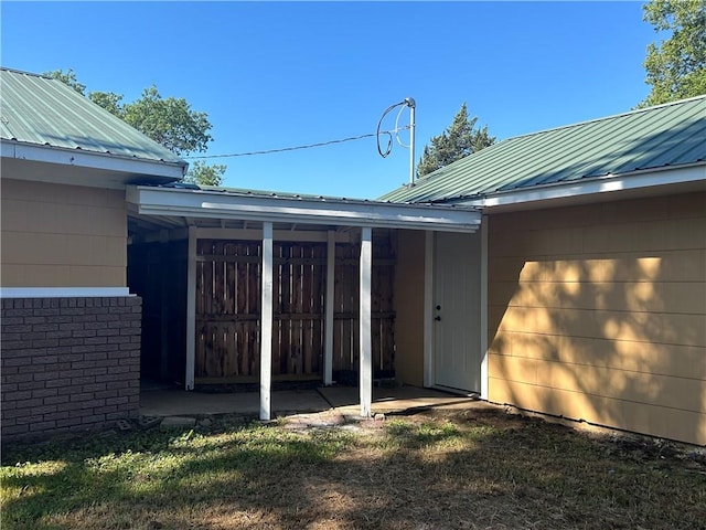 property entrance with a lawn